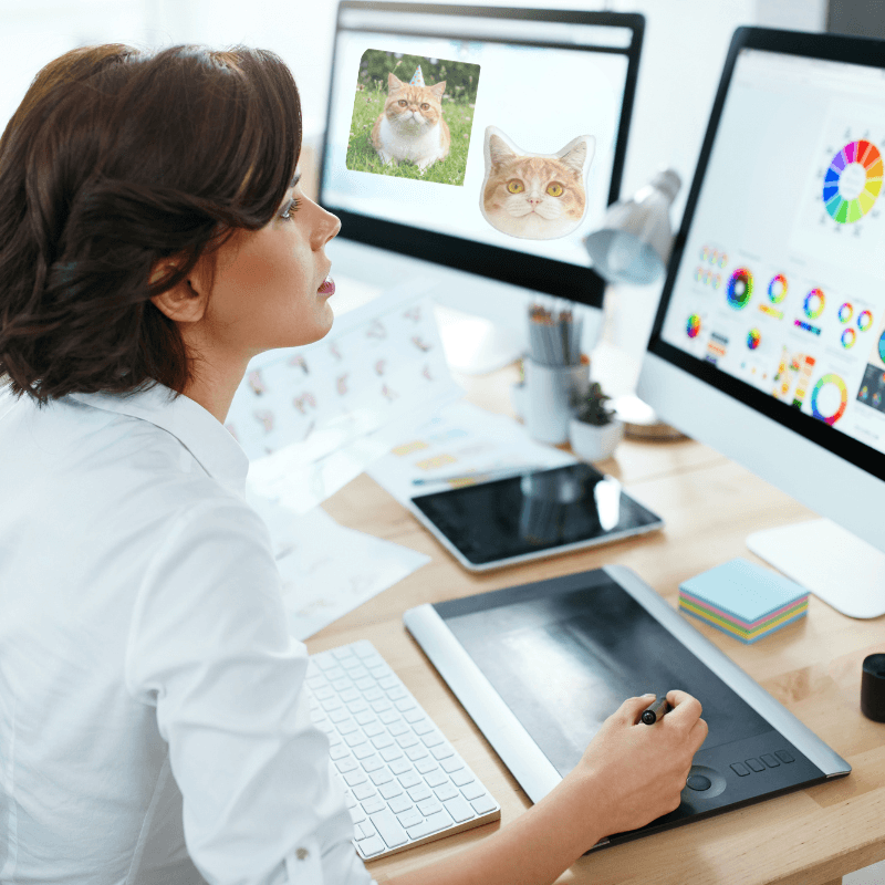 Professional designer crafting a digital pet portrait preview on a computer at 1PawPrint studio.
