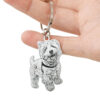 Personalized custom engraved silver dog ID tag held in hand
