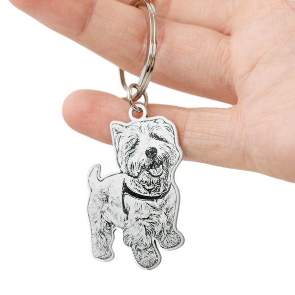 Personalized custom engraved silver dog ID tag held in hand
