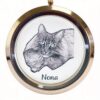 Close up of a custom cat portrait engraved inside a rose gold locket pendant