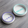 Two personalized marble-style pet bowls with engraved names Luna and Bruno for dogs and cats.