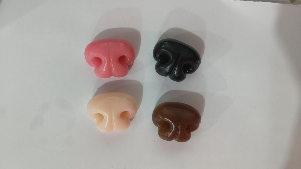 Close up of colorful 3D Q-elastic silicone noses for custom pet portrait magnets