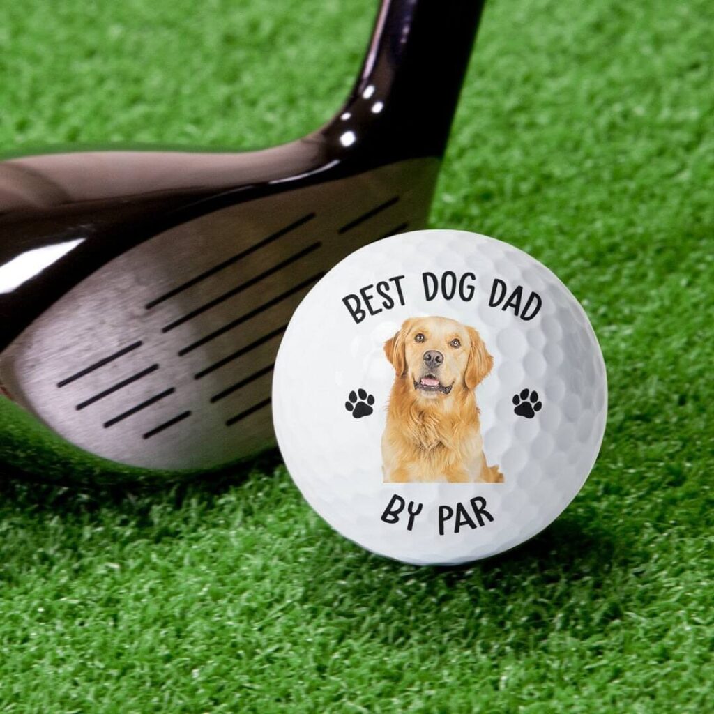 Custom dog photo golf ball displayed next to a golf club for pet lovers
