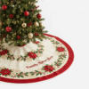 Custom family name Christmas tree skirt with festive poinsettia and holly leaf border design