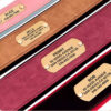 Collection of personalized wide dog collars featuring engraved metal name plates.