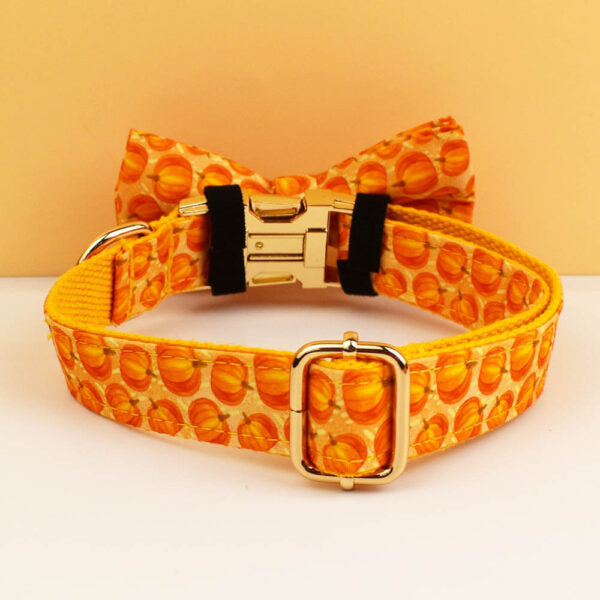 Personalized orange pumpkin dog collar featuring gold buckle and bow tie detail